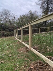 A wood frame fence with wire mesh installed by Escamilla Fence Co. in Knoxville, TN