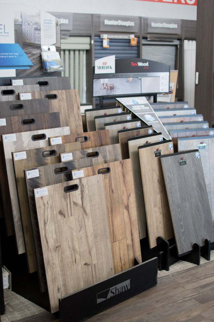 Various wood-look laminate and vinyl flooring samples displayed at Carpet King Interiors / Abbey Carpet & Floor in Fernley, NV.