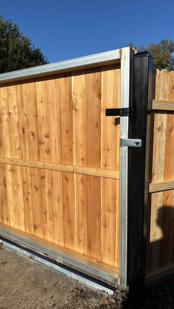 A sturdy wood pedestrian gate with a metal frame and secure latch by Franco Fence in Garland, TX.