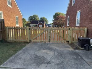 A wood picket fence with a double gate installed by Shatkoff Fencing in Louisville, KY.