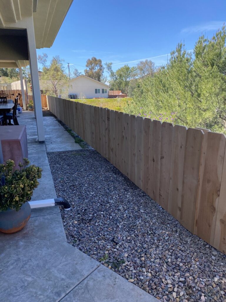 A newly installed wood picket fence along a property line by All Around Fence Page in Imperial Beach, CA.