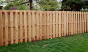A newly installed wood picket fence in a residential yard by Weber Fence LLC in Baton Rouge, LA.