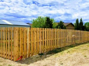 A classic wood picket fence installed in a residential area by Prestige Fencing LLC in Medford, OR.