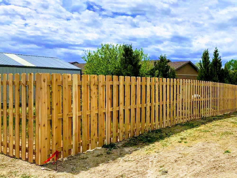 A classic wood picket fence installed in a residential area by Prestige Fencing LLC in Medford, OR.