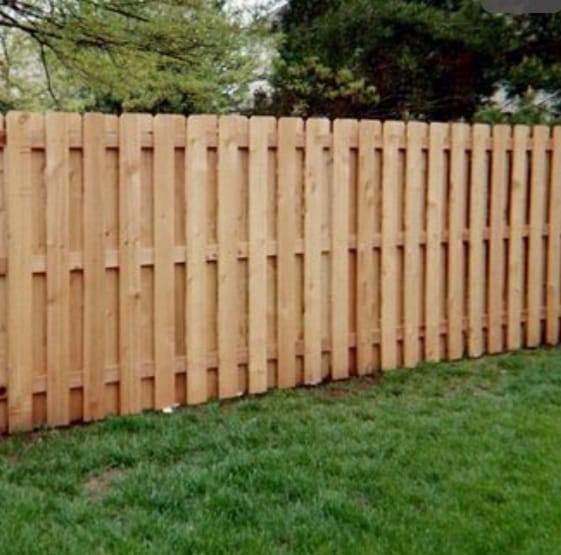 A newly installed wood picket privacy fence by Weber Deck & Fence in Baton Rouge, LA.