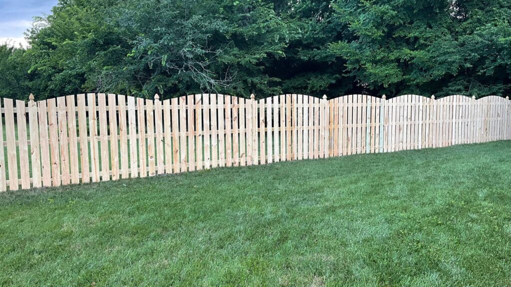 A charming wood picket fence with a scalloped top installed by Superior Fence & Rail of Charlotte, NC