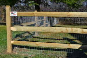 A wood post and wire mesh fence installed by Master Fences, suitable for rural or animal enclosures in Gaithersburg, MD.