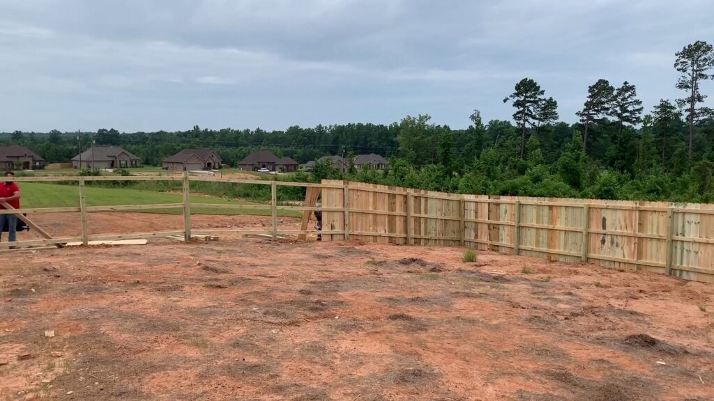 Wood privacy and split rail fence under construction in a residential area by Precision Fence in Meridian, MS.