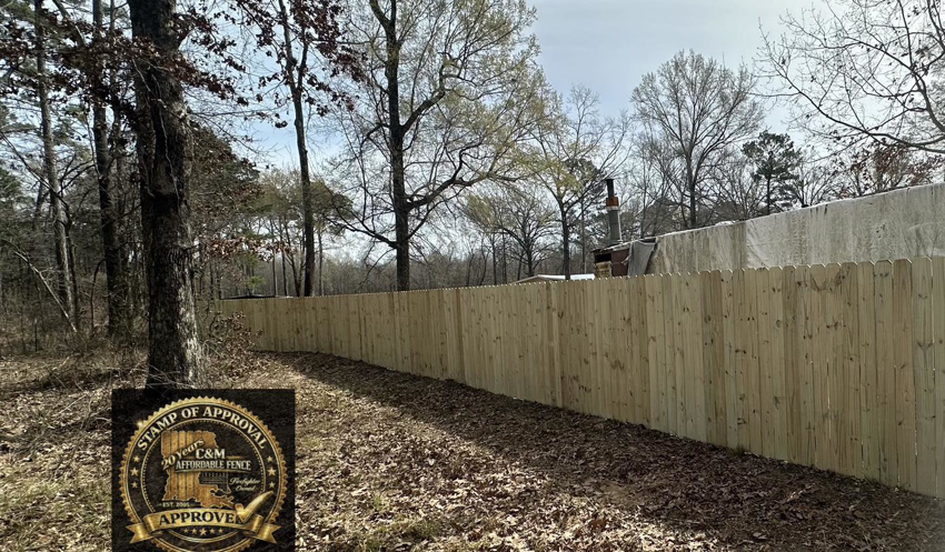 A wood privacy fence running along a property line, installed by C & M Affordable Fence, LLC in Haughton, LA