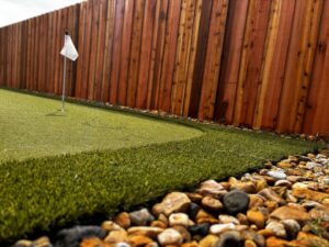 A new wood privacy fence installed around a putting green by Lynch's Lawn & Fence LLC in Bossier City, LA.