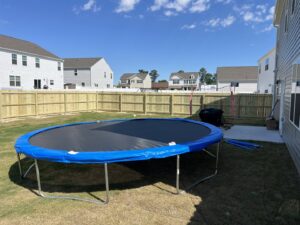 A newly installed wood privacy fence enclosing a residential backyard by Fencingphd.nc in Fayetteville, NC.