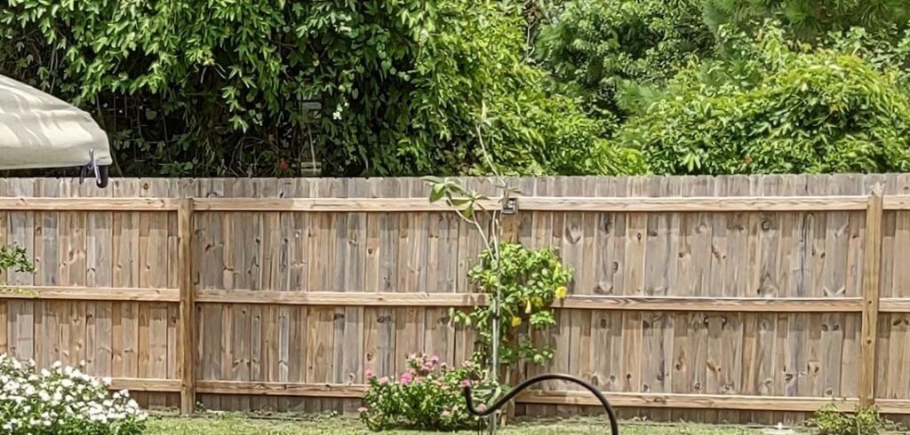 A classic wood privacy fence providing security and charm to a backyard, installed by Inovation Fence in Fort Worth, TX.