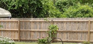 A classic wood privacy fence providing security and charm to a backyard, installed by Inovation Fence in Fort Worth, TX.
