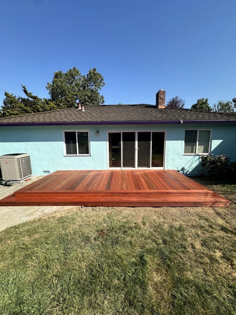 A newly installed wood privacy fence in a backyard by Jaz Builders Inc in Santa Clara, CA.