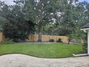 A classic wood privacy fence installed in a residential backyard by Masters Fence Contracting in Jacksonville, FL.
