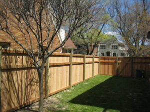 A tall wooden privacy fence installed in a residential backyard by Metrofence in Grand Rapids, MI.