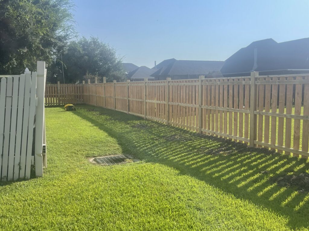 A newly installed wood privacy fence surrounding a residential backyard by Southern Fencing, LLC in Houma, LA.