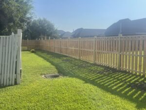 A newly installed wood privacy fence surrounding a residential backyard by Southern Fencing, LLC in Houma, LA.