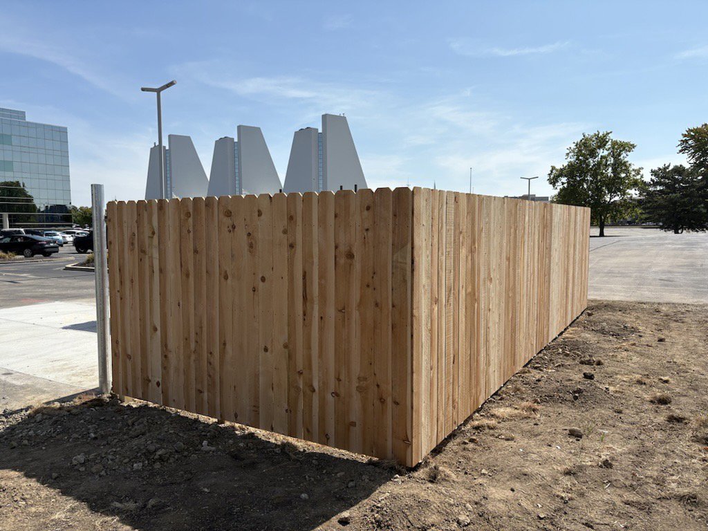 A wood privacy fence installed around a commercial parking area by Cameron Fence Builders in Indianapolis, IN.