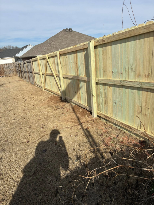 New wood privacy fence construction showing support beams by Stronghold Fence and Construction in Springdale, AR.