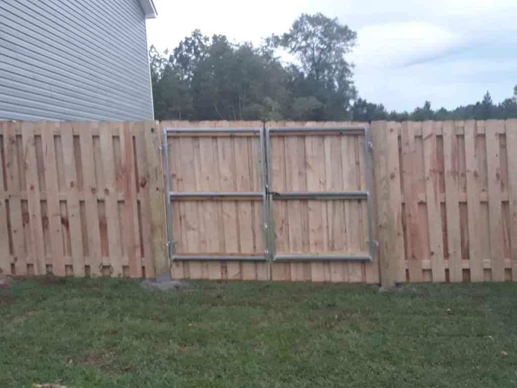 A wood privacy fence with a double gate installed by Rowe Fence & Supply in New Kent, VA.