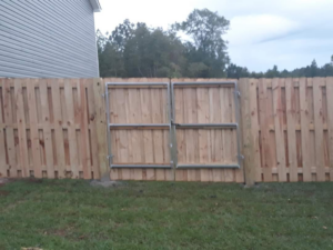 A wood privacy fence with a double gate installed by Rowe Fence & Supply in New Kent, VA.