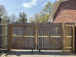 A wood privacy fence with a double gate installed by Shatkoff Fencing in Louisville, KY.