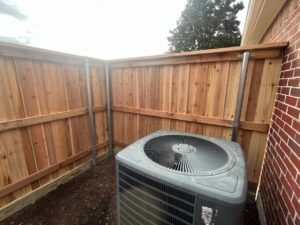 A custom wood privacy fence built to enclose an AC unit by Stand Strong Fencing of Plano, TX
