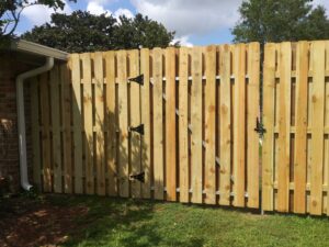 A newly constructed wood privacy fence and gate, highlighting the craftsmanship of Country Boyz fencing in Biloxi, MS.