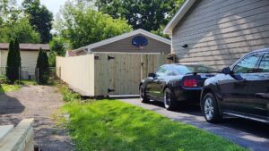 Wood privacy fence and gate installed along a driveway by All Terrain Fence LLC in Waukegan, IL