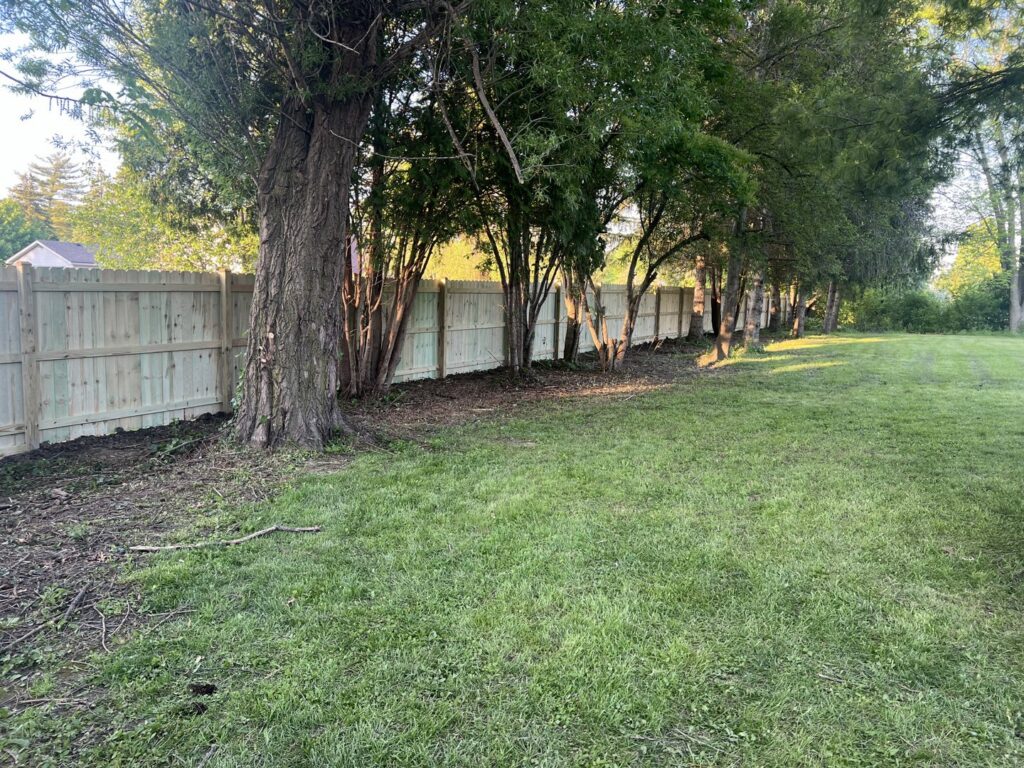 Wood privacy fence with a gate installed next to a house by All Terrain Fence LLC in Waukegan, IL