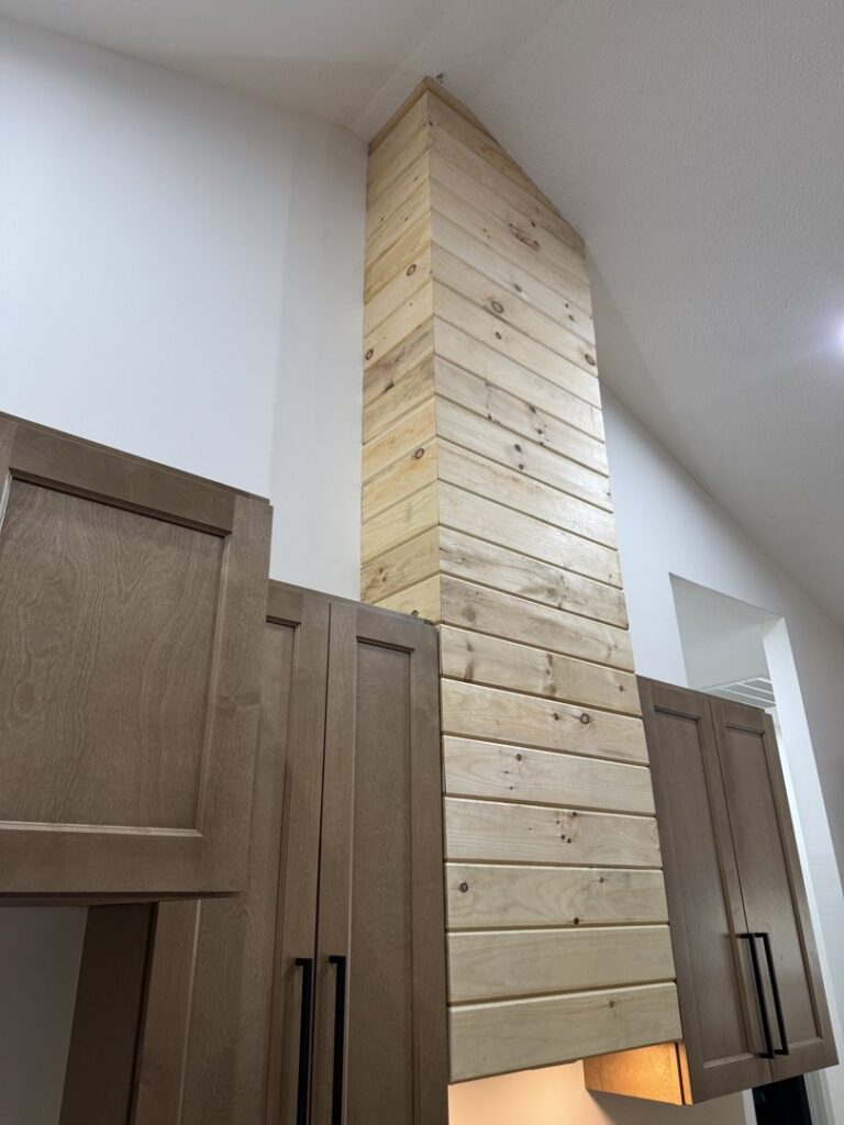 A newly installed wood privacy fence and gate next to a residential house by Faithful Fencing LLC in Batesville, AR.