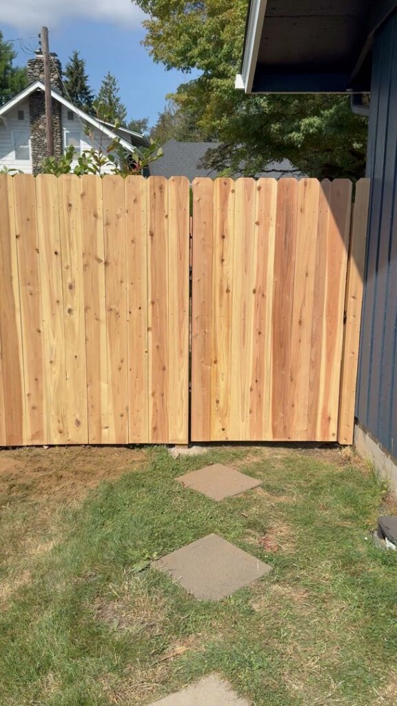 A wood privacy fence with a matching gate installed for a residential property by Clark County Fence LLC in Vancouver, WA.