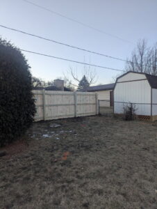 Wood privacy fence with a gate installed in a side yard by All Terrain Fence LLC in Waukegan, IL