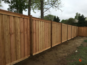 A newly installed wood privacy fence in a residential area by Freedom Fencing of Clarksville, TN.