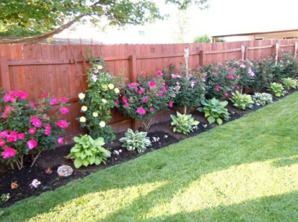 A wood privacy fence complementing backyard landscaping by Barney's Landscaping in Dayton, OH.