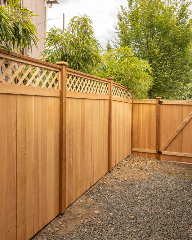 A beautiful wood privacy fence with a lattice top and matching gate, installed by Alpine Fencing in Everett, WA.