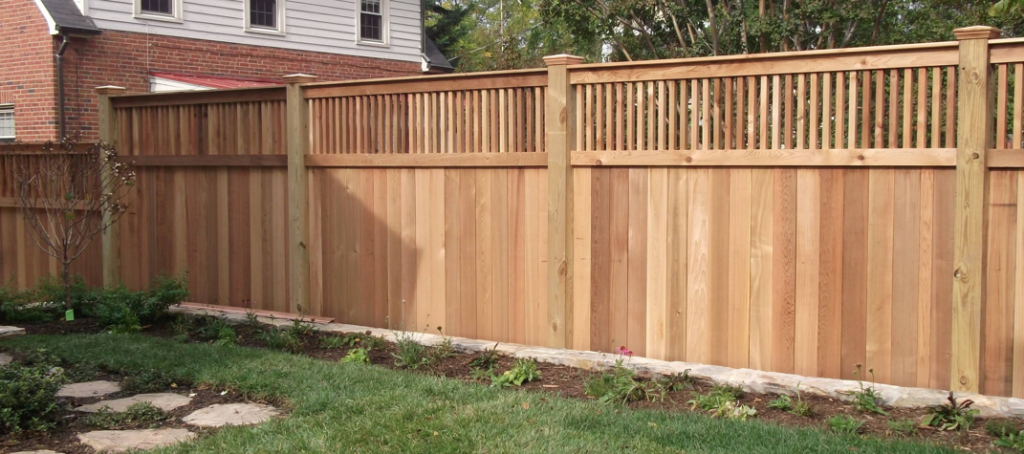 A beautiful wooden privacy fence with a decorative lattice top installed by ICT Fence in Wichita, KS.