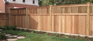 A beautiful wooden privacy fence with a decorative lattice top installed by ICT Fence in Wichita, KS.