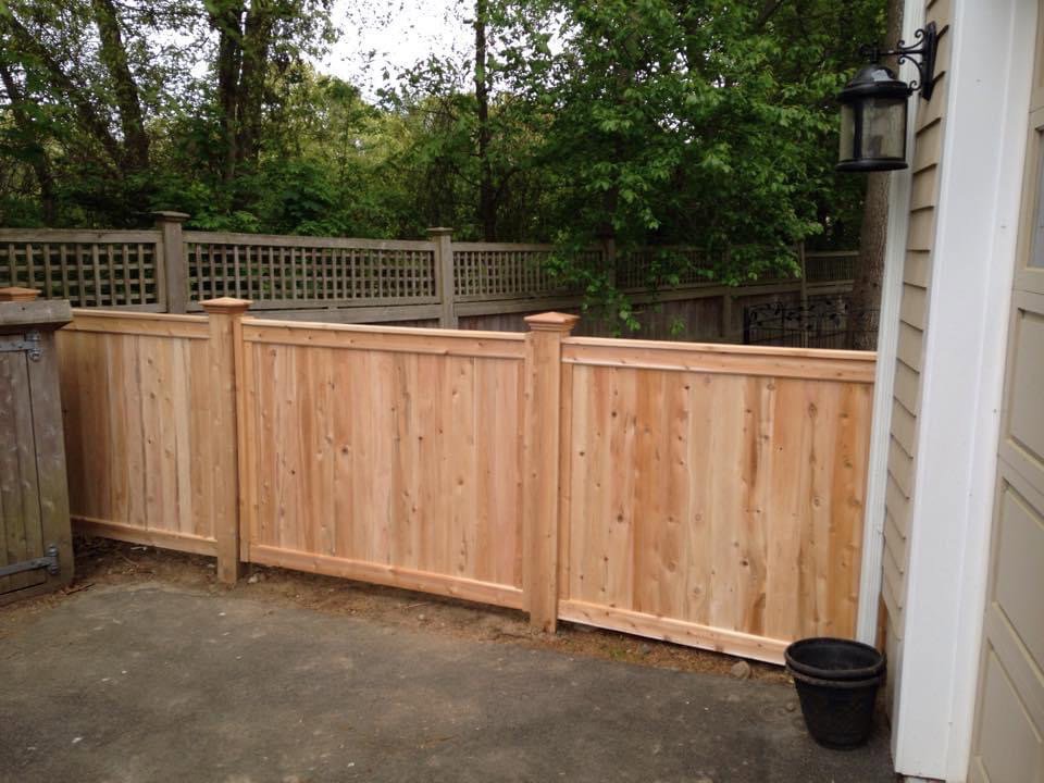 Wood privacy fence with a decorative lattice top installed by Louis Fence installations & repairs in Fall River, MA