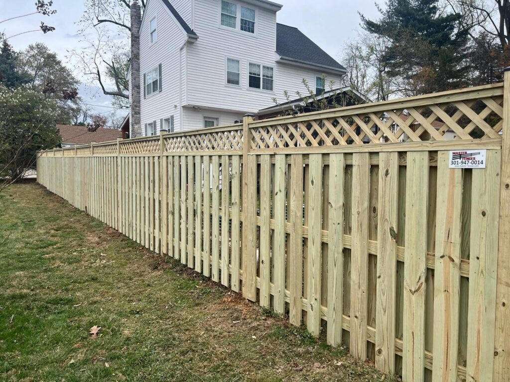 A wood privacy fence with a decorative lattice top installed by Master Fences in Gaithersburg, MD.
