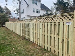 A wood privacy fence with a decorative lattice top installed by Master Fences in Gaithersburg, MD.