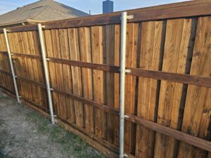 A durable wood privacy fence reinforced with metal posts by Stand Strong Fencing of Plano, TX