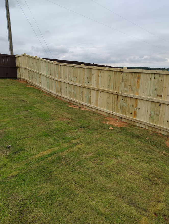 A wood privacy fence expertly installed on sloping terrain by Maine Wood Fencing & more in Greenville, SC.