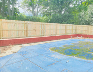 A completed wood privacy fence surrounding a pool area by Superior Fence & Rail of Northern Kentucky in Florence, KY.