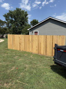 A newly installed wood privacy fence in a residential backyard by NC Fencing LLC in Wichita, KS.
