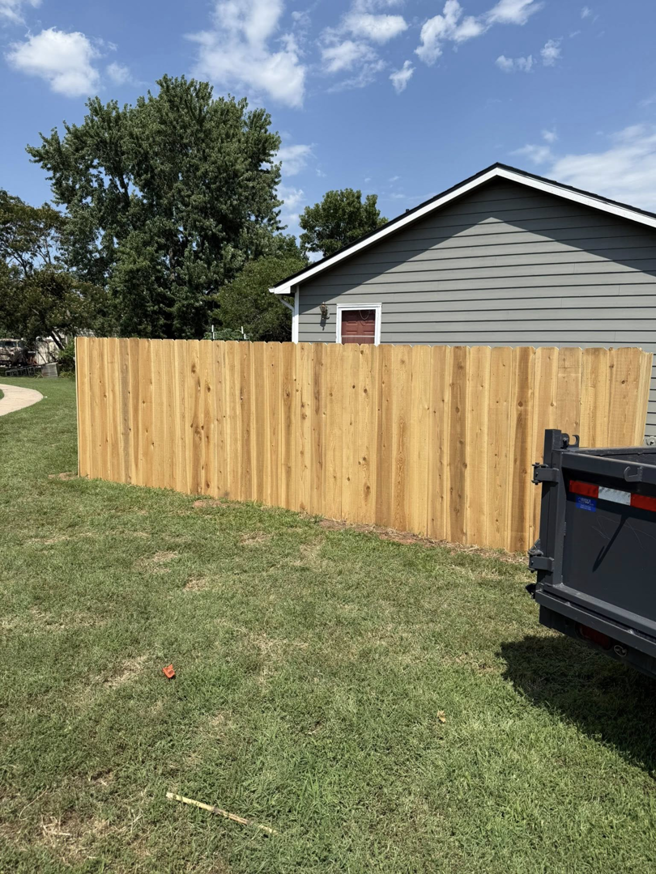 A newly installed wood privacy fence in a residential backyard by NC Fencing LLC in Wichita, KS.