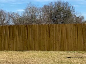 A tall wood privacy fence providing security and seclusion for a residential property by National Fence Services, LLC in Macon, GA.