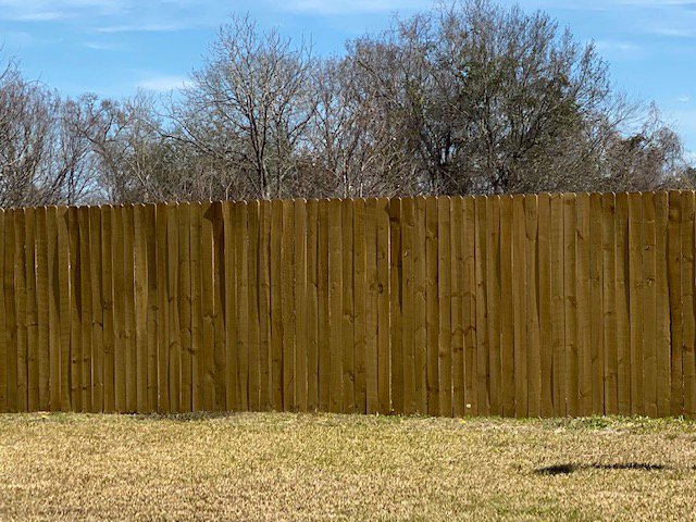 A tall wood privacy fence providing security and seclusion for a residential property by National Fence Services, LLC in Macon, GA.