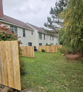 Wood privacy fencing installed in a townhouse backyard, providing separation by Dirigo Fence Company in Augusta, ME.